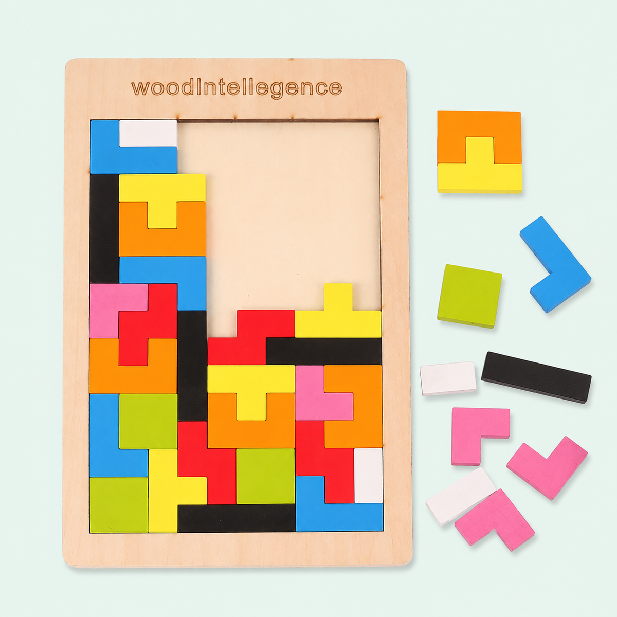 A wooden puzzle board with colorful geometric pieces arranged inside, plus several loose matching pieces on the right. The board is engraved with the brand name 'woodIntelligence'.